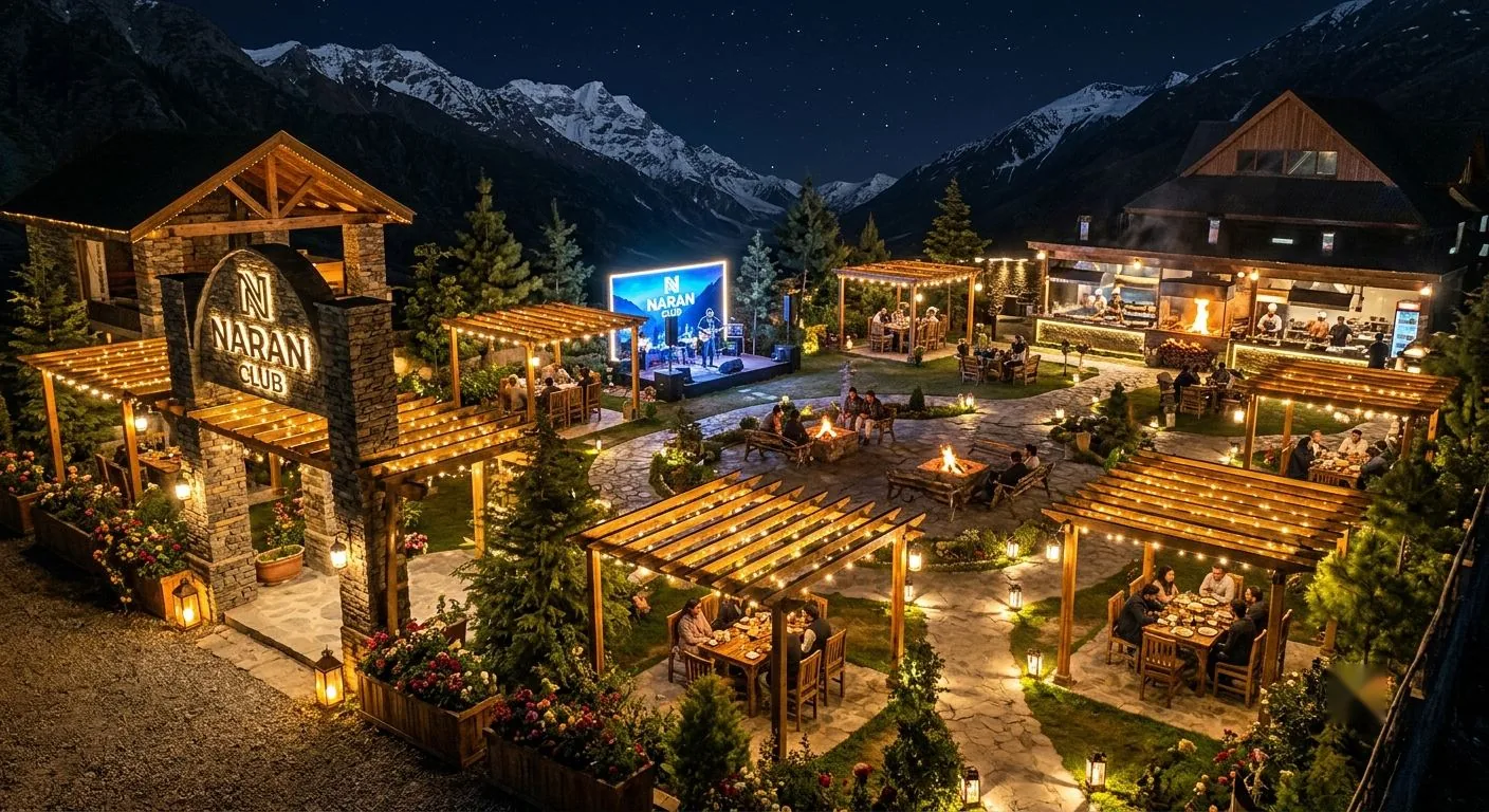 The Naran Club courtyard at night, lantern-lit with dining, fire pits and a stage beneath the mountains