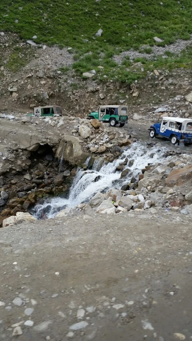 Jeeps fording a mountain stream on the track to Saif-ul-Malook